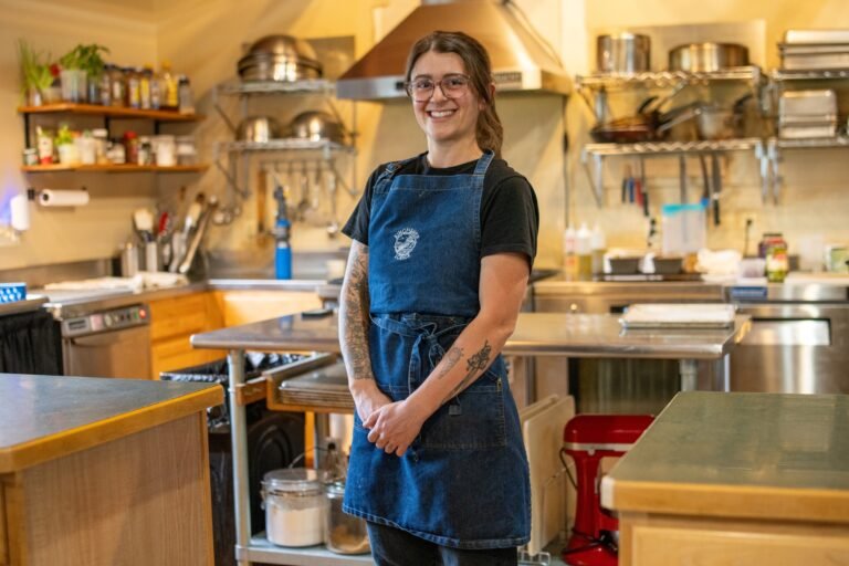 Kingfisher Lodge Chef, Hannah is standing in front of the kitchen.