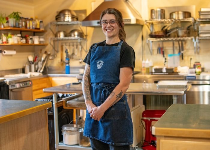 Kingfisher Lodge Chef, Hannah is standing in front of the kitchen.